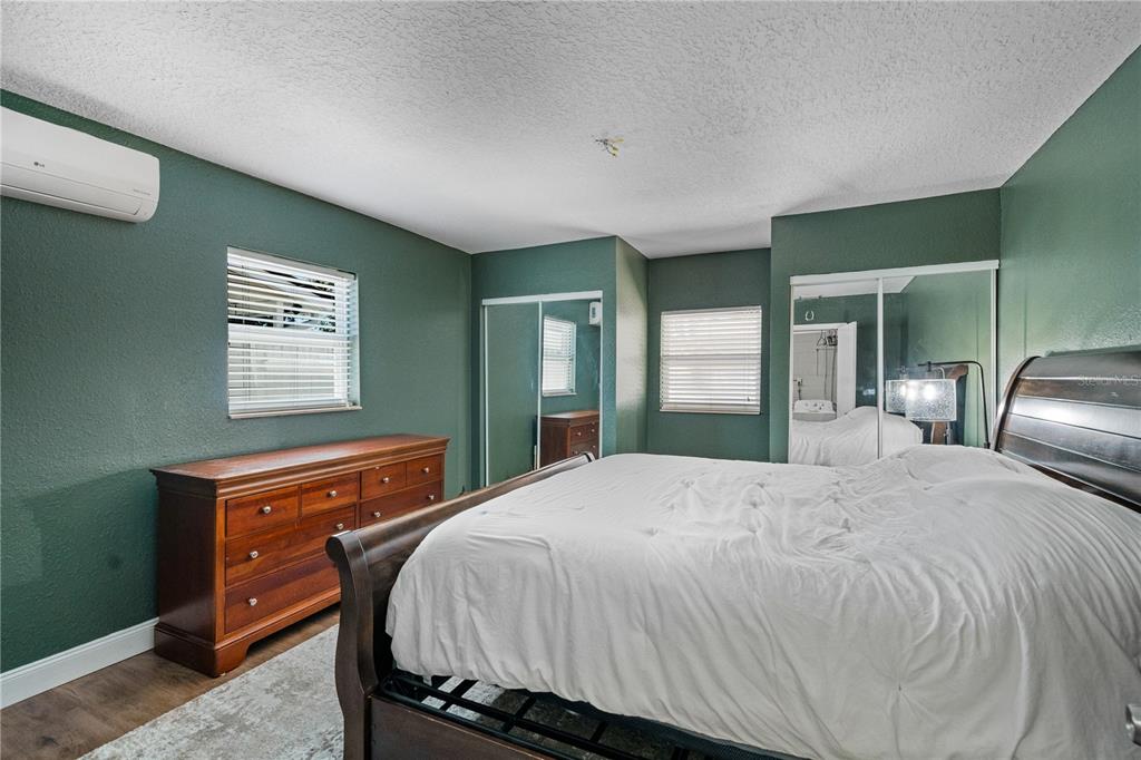 9653 Golden Grove Street Seminole, FL 33772 - Photo 12 of 29 a bedroom with a bed and a dresser with mirror