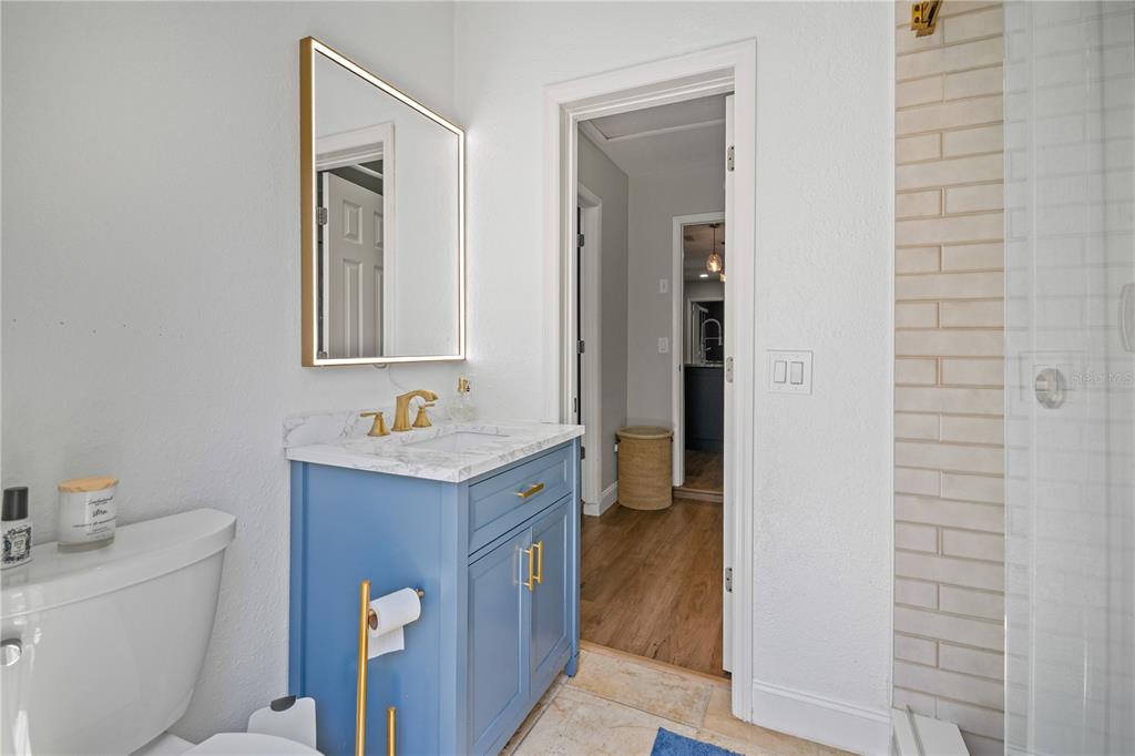 9653 Golden Grove Street Seminole, FL 33772 - Photo 14 of 29 a bathroom with a sink a toilet and mirror