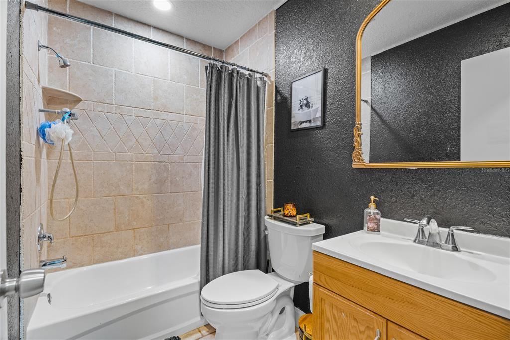 9653 Golden Grove Street Seminole, FL 33772 - Photo 16 of 29 a bathroom with a sink toilet and shower