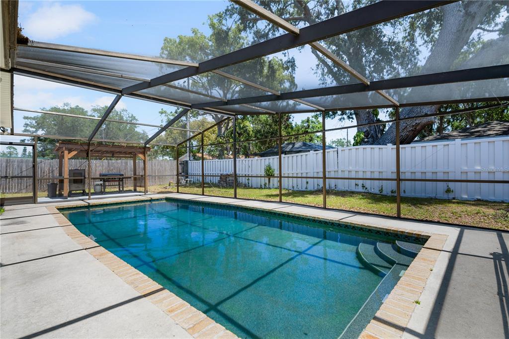 9653 Golden Grove Street Seminole, FL 33772 - Photo 20 of 29 a view of swimming pool with a backyard