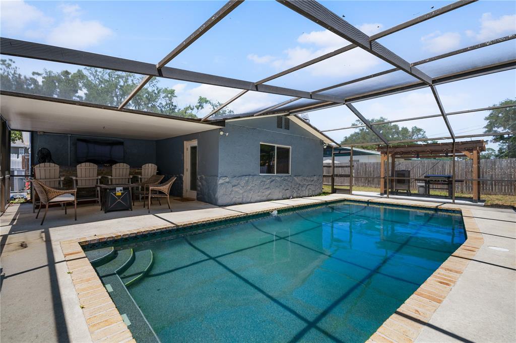9653 Golden Grove Street Seminole, FL 33772 - Photo 21 of 29 a view of a backyard with pool table and chairs