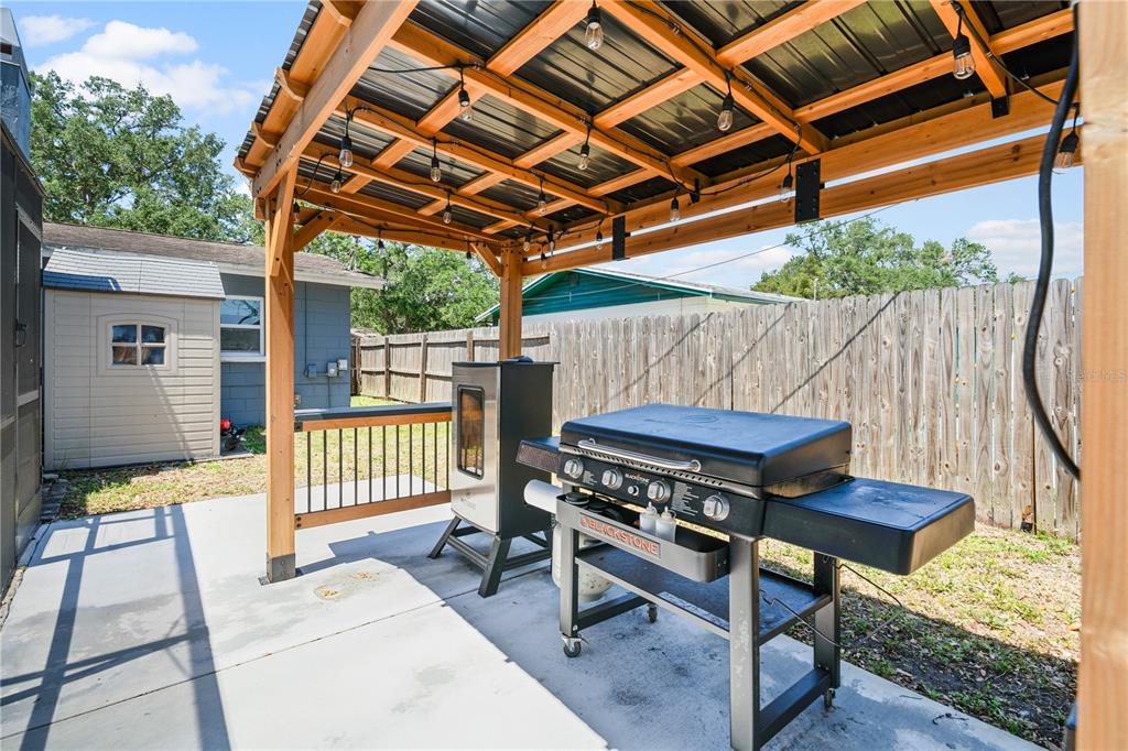 9653 Golden Grove Street Seminole, FL 33772 - Photo 25 of 29 a view of a backyard with a small deck and a patio