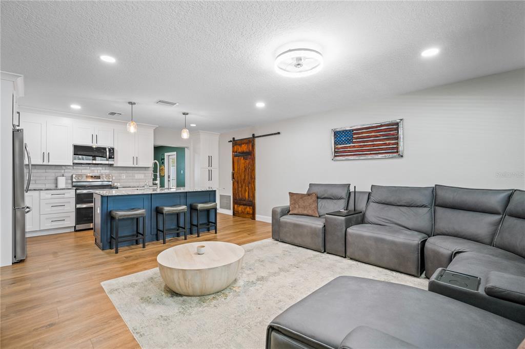 9653 Golden Grove Street Seminole, FL 33772 - Photo 6 of 29 a living room with furniture and a wooden floor