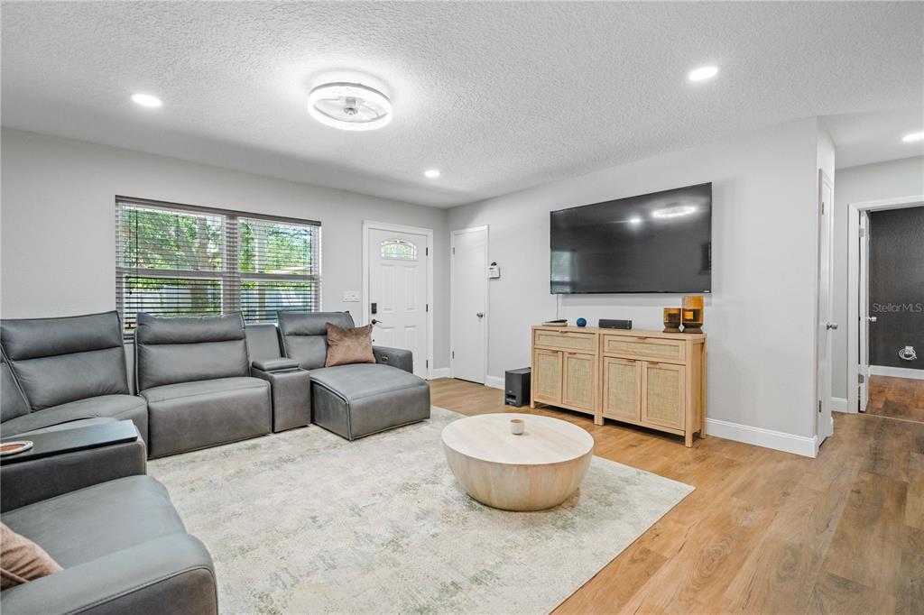9653 Golden Grove Street Seminole, FL 33772 - Photo 7 of 29 a living room with furniture and a flat screen tv