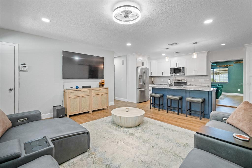 9653 Golden Grove Street Seminole, FL 33772 - Photo 8 of 29 a living room with furniture and a flat screen tv