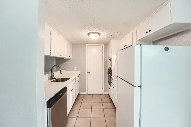 a kitchen with stainless steel appliances a refrigerator and a stove