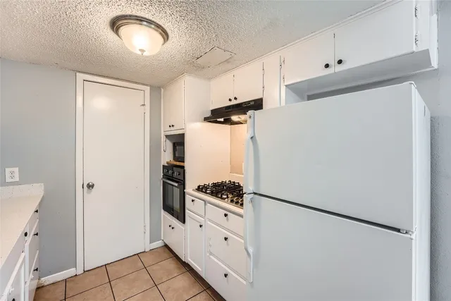 a kitchen with stainless steel appliances a refrigerator and a stove
