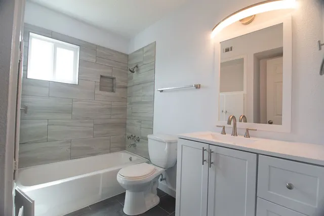 a bathroom with a sink a toilet and bathtub