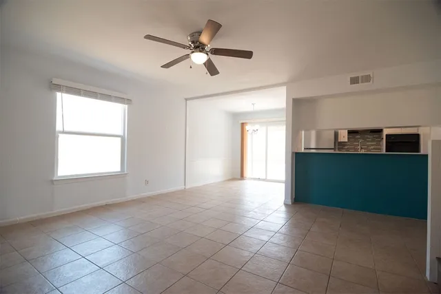 a view of a livingroom with a ceiling fan and window