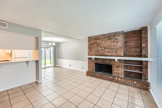 a living room with a fireplace furniture and a large window