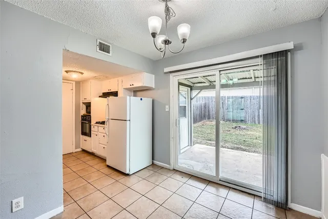 a view of a refrigerator in kitchen and a glass door