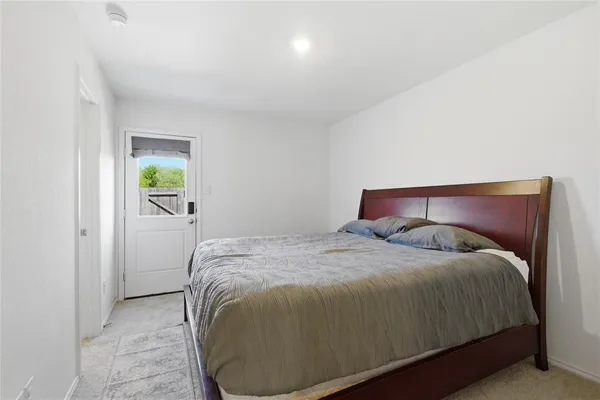 a bed sitting in a bedroom next to a window