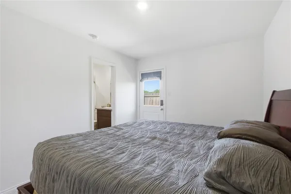 a bedroom with a bed and window