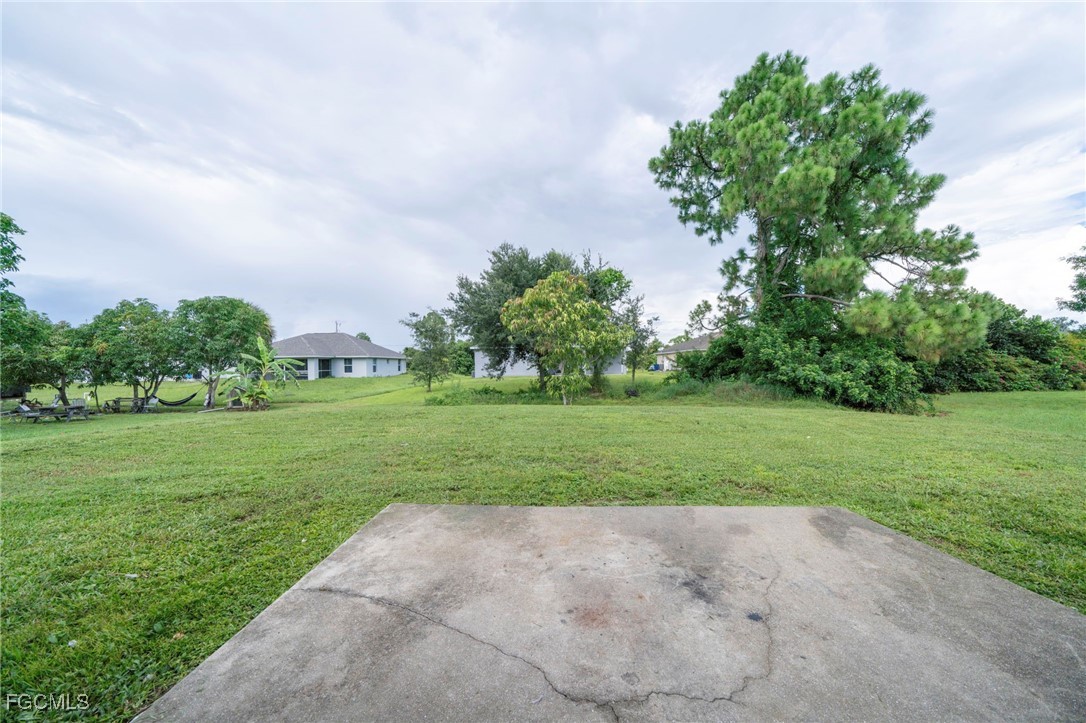4306 11th Street Southwest Lehigh Acres, FL 33976 - Photo 16 of 17 a view of a park and trees in the background