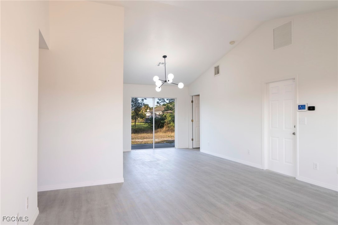 4306 11th Street Southwest Lehigh Acres, FL 33976 - Photo 2 of 17 a view of an empty room with wooden floor