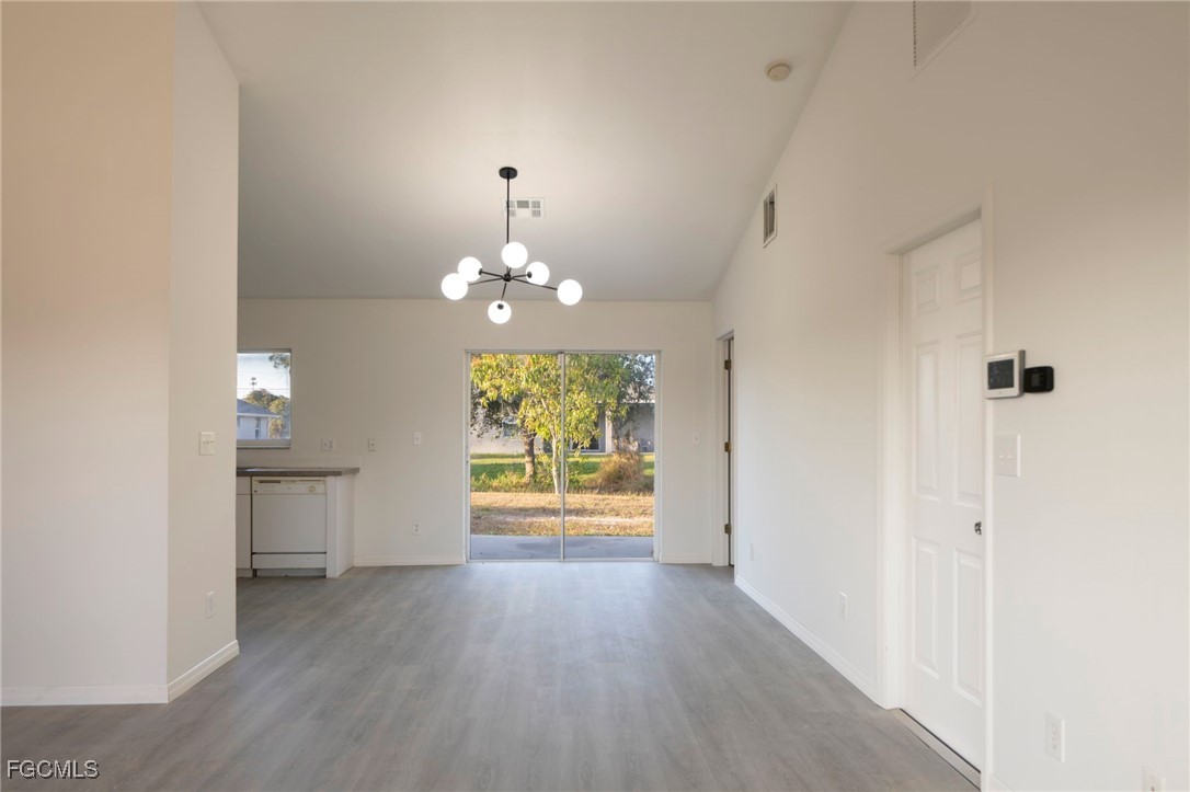 4306 11th Street Southwest Lehigh Acres, FL 33976 - Photo 3 of 17 wooden floor in an empty room with a window