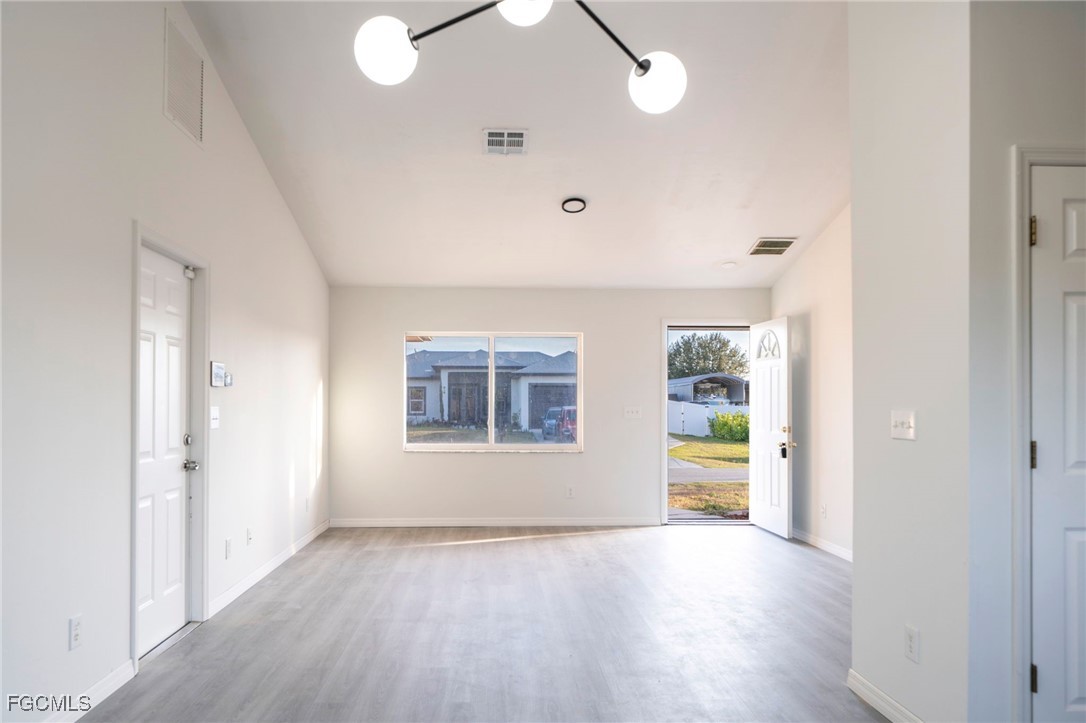 4306 11th Street Southwest Lehigh Acres, FL 33976 - Photo 4 of 17 wooden floor in an empty room