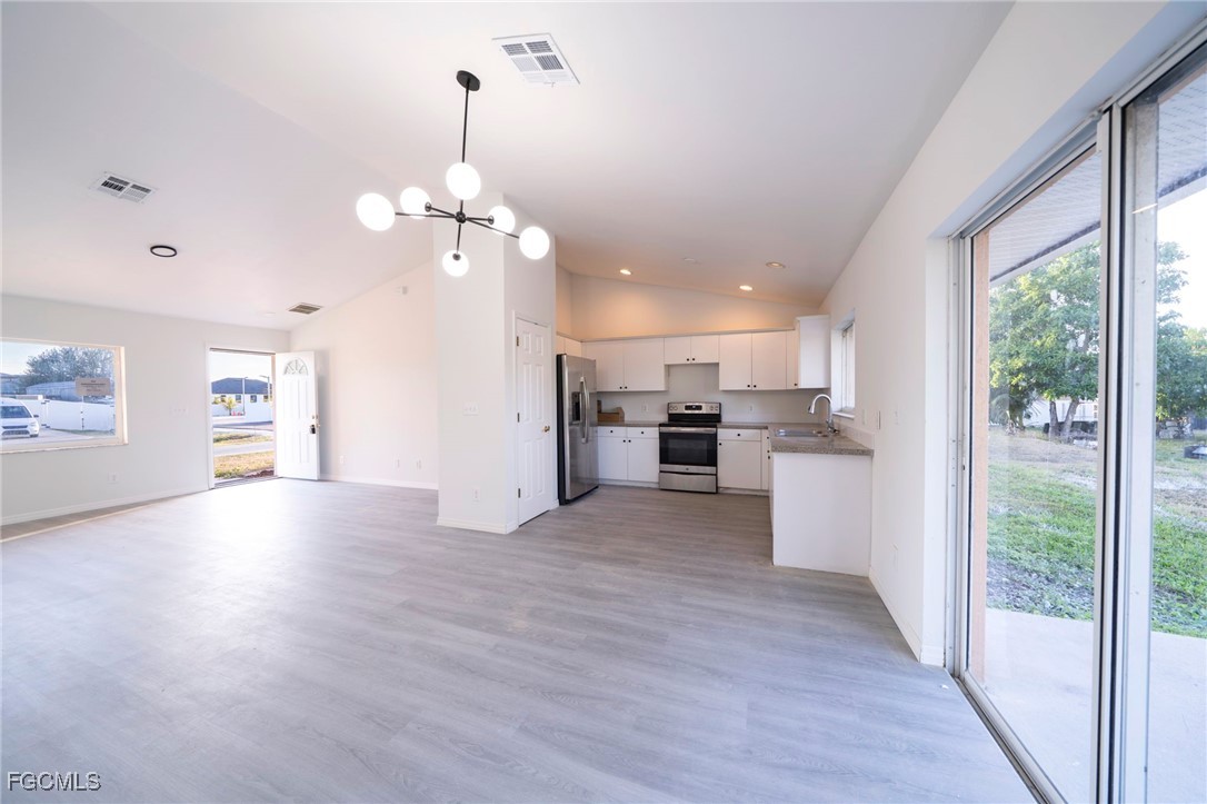 4306 11th Street Southwest Lehigh Acres, FL 33976 - Photo 6 of 17 a view of a kitchen with wooden floor and a kitchen