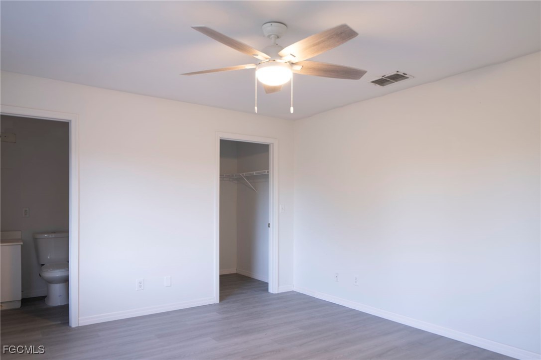 4306 11th Street Southwest Lehigh Acres, FL 33976 - Photo 8 of 17 wooden floor in an empty room