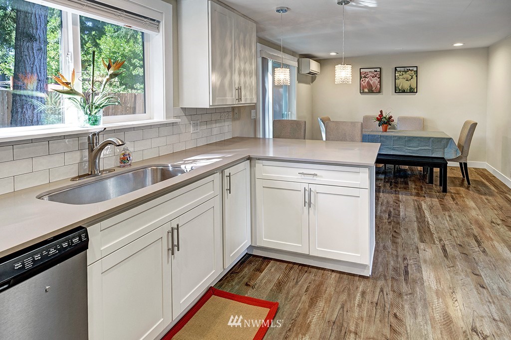 11225 Southeast 22nd Street Renton, WA 98055 - Photo 12 of 28 a kitchen with sink cabinets and wooden floor