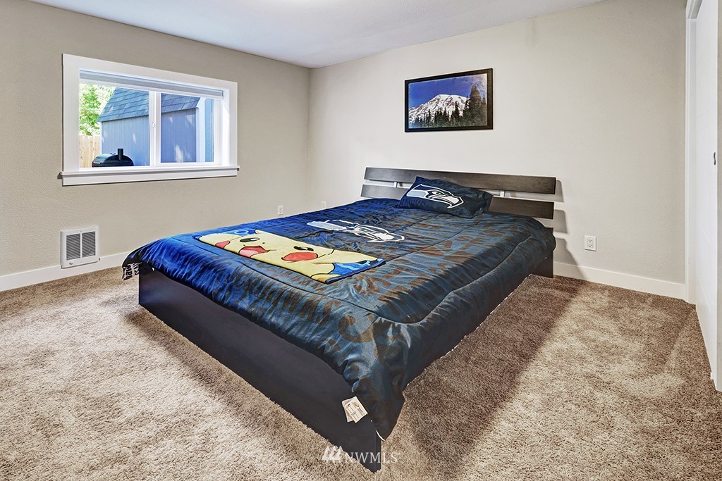 11225 Southeast 22nd Street Renton, WA 98055 - Photo 19 of 28 a bed sitting in a bedroom next to a window