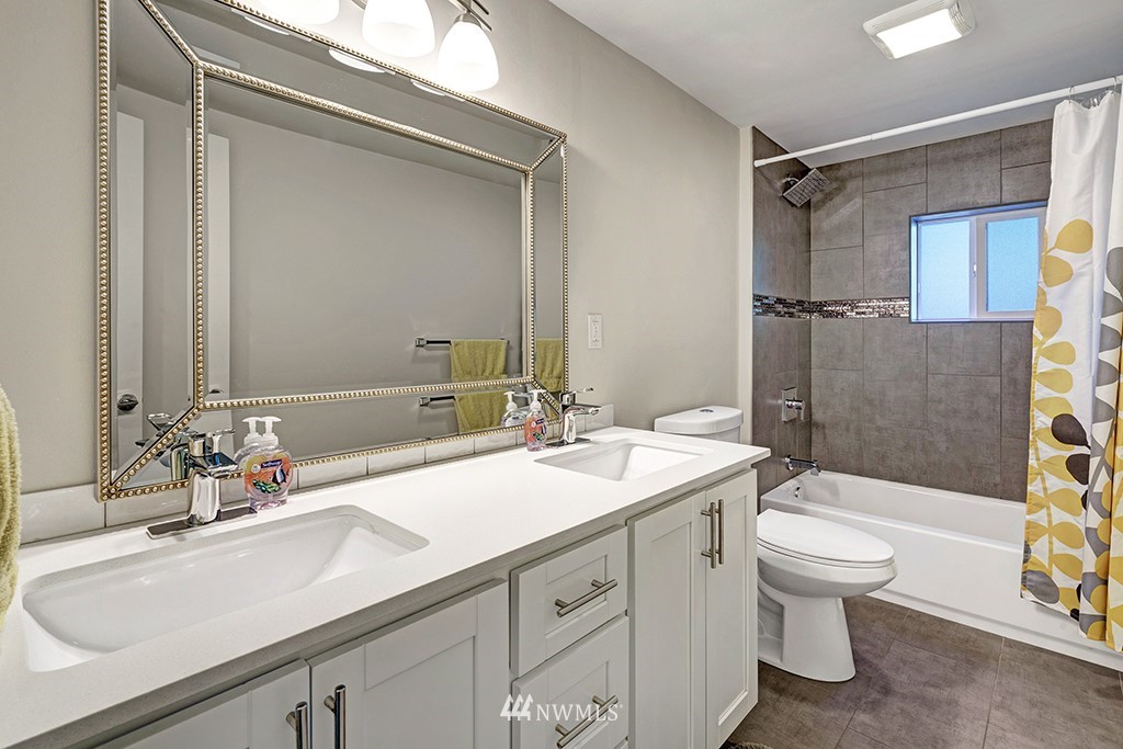 11225 Southeast 22nd Street Renton, WA 98055 - Photo 22 of 28 a bathroom with a sink a toilet and shower