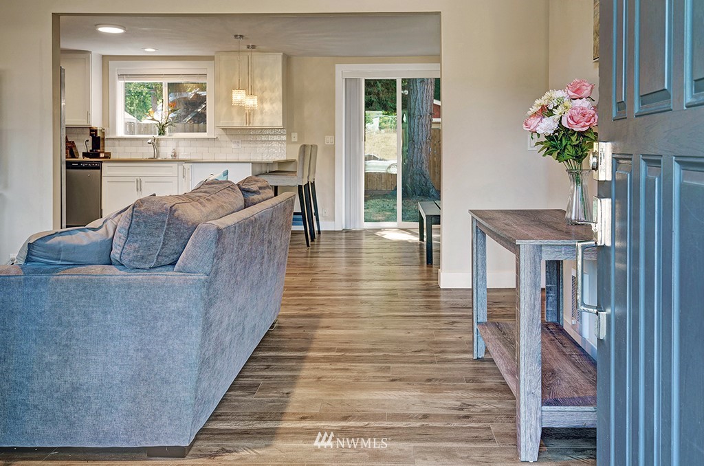 11225 Southeast 22nd Street Renton, WA 98055 - Photo 5 of 28 a living room with stainless steel appliances kitchen island granite countertop furniture wooden floor and a view of kitchen