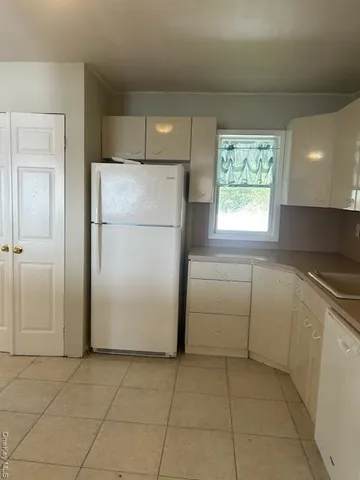 a utility room with cabinets washer and dryer
