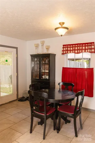a living room with furniture a rug and a window