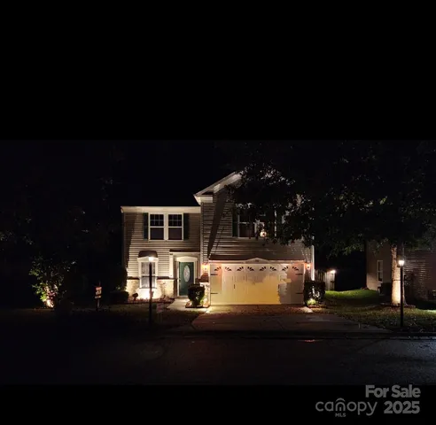 a view of street with view of a house with a yard