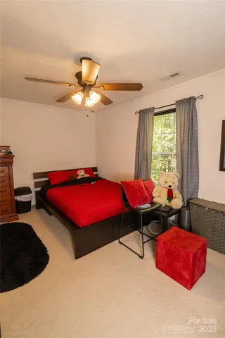 a bedroom with furniture and a chandelier