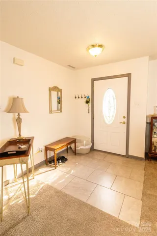 a view of a livingroom with furniture and a potted plant
