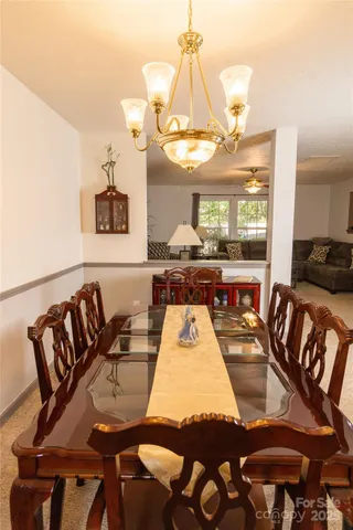a view of a dining room with furniture and chandelier