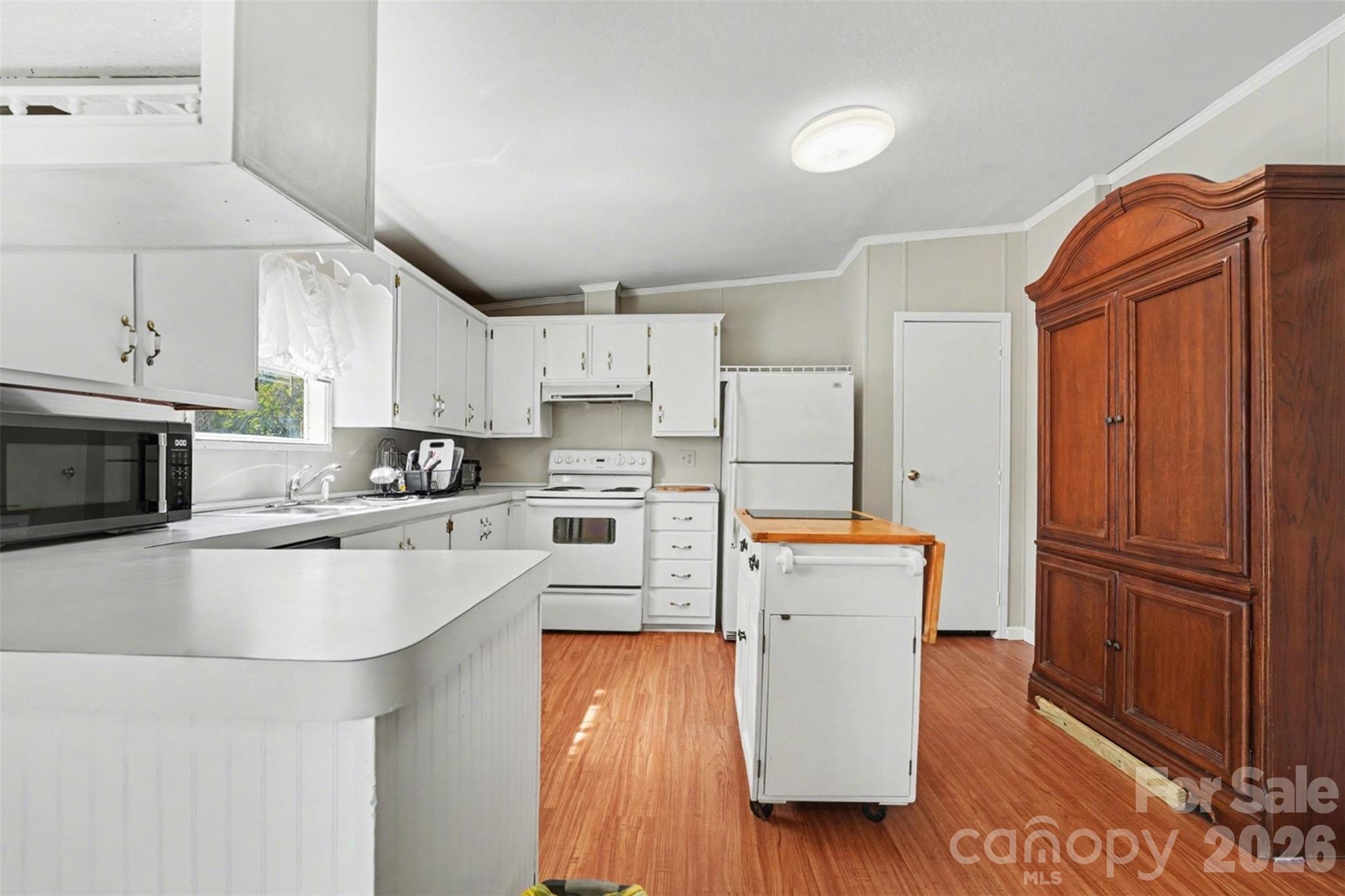 940 John Miller Road Rockwell, NC 28138 - Photo 16 of 28 a kitchen with cabinets and wooden floor