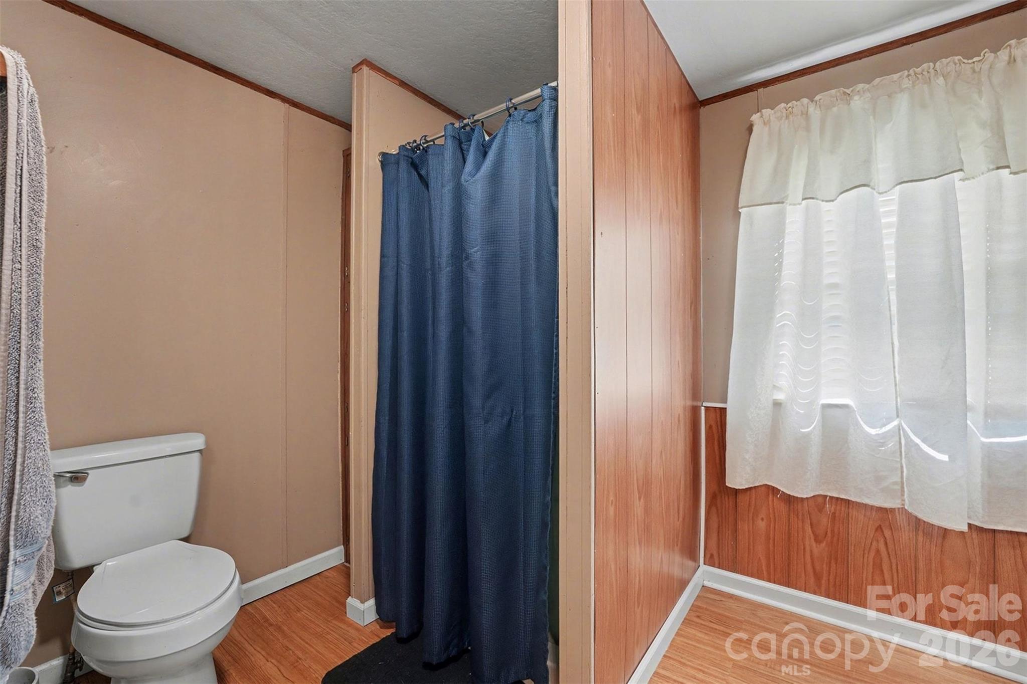 940 John Miller Road Rockwell, NC 28138 - Photo 17 of 28 a bathroom with a toilet and a shower curtain