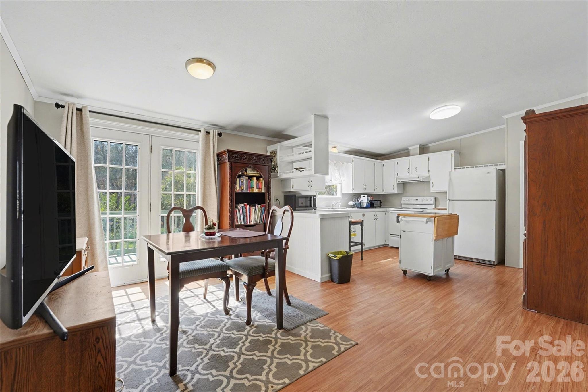 940 John Miller Road Rockwell, NC 28138 - Photo 19 of 28 a living room with stainless steel appliances furniture a dining table and a refrigerator