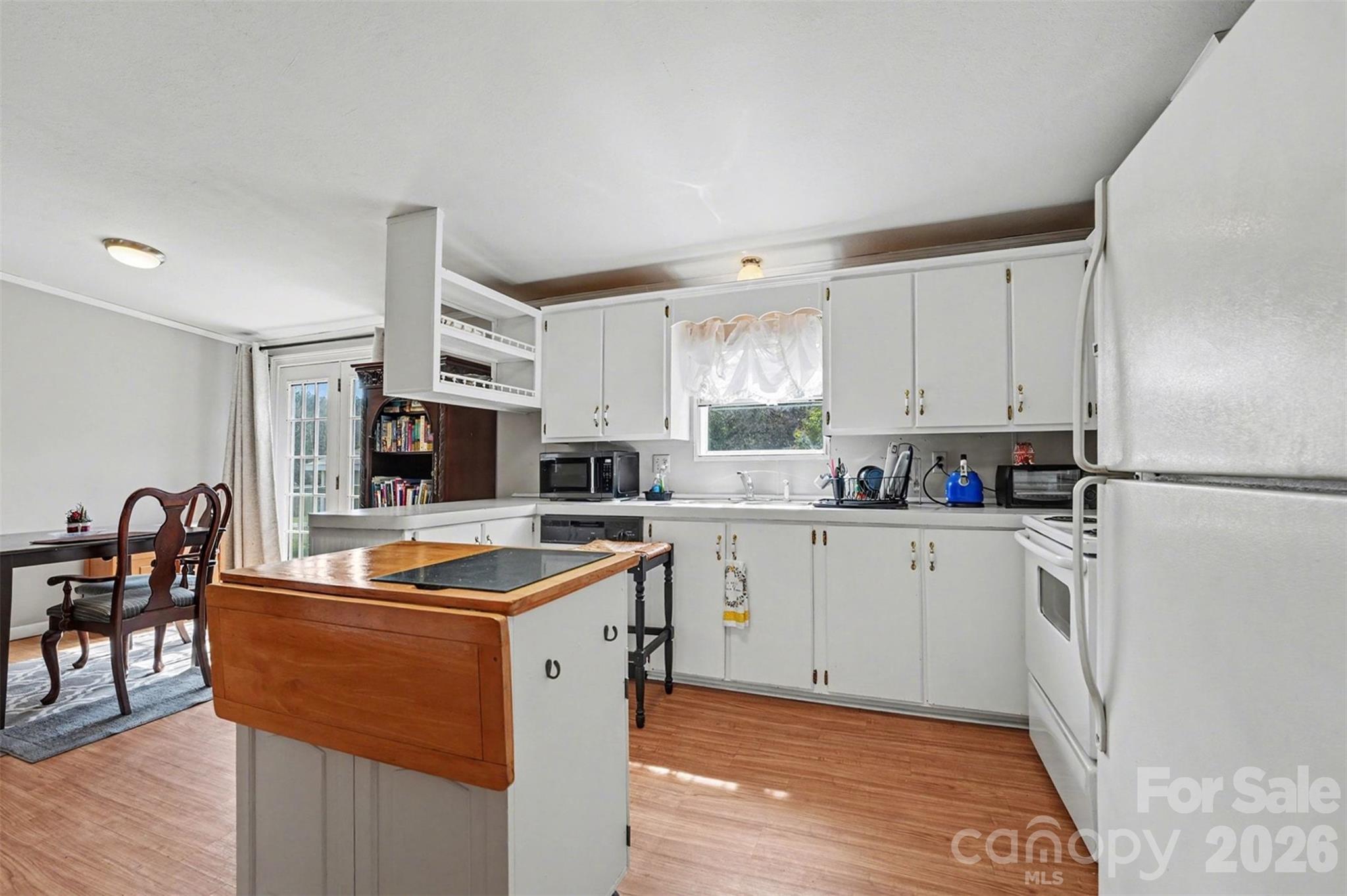 940 John Miller Road Rockwell, NC 28138 - Photo 20 of 28 a kitchen with stainless steel appliances granite countertop a sink a stove a refrigerator cabinets and chairs