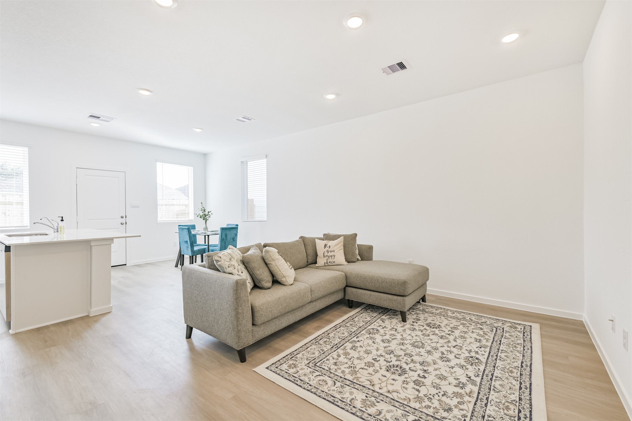 819 Sweet Jubilee Lane Houston, TX 77090 - Photo 11 of 25 a living room with a couch and white kitchen with wooden floor