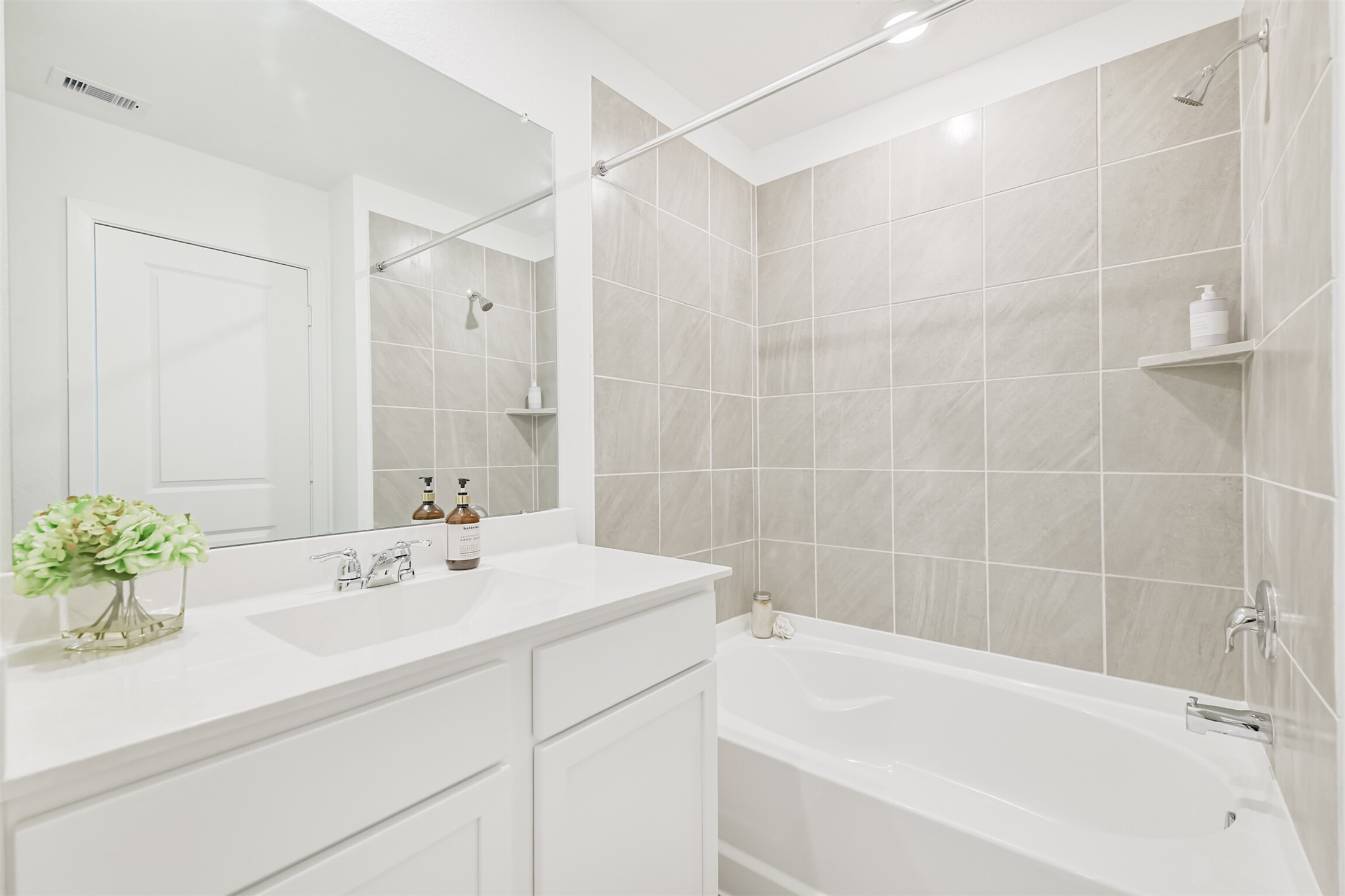 819 Sweet Jubilee Lane Houston, TX 77090 - Photo 12 of 25 a bathroom with a sink tub shower and a mirror