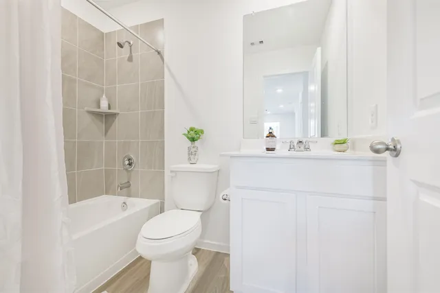 a bathroom with a sink toilet and shower