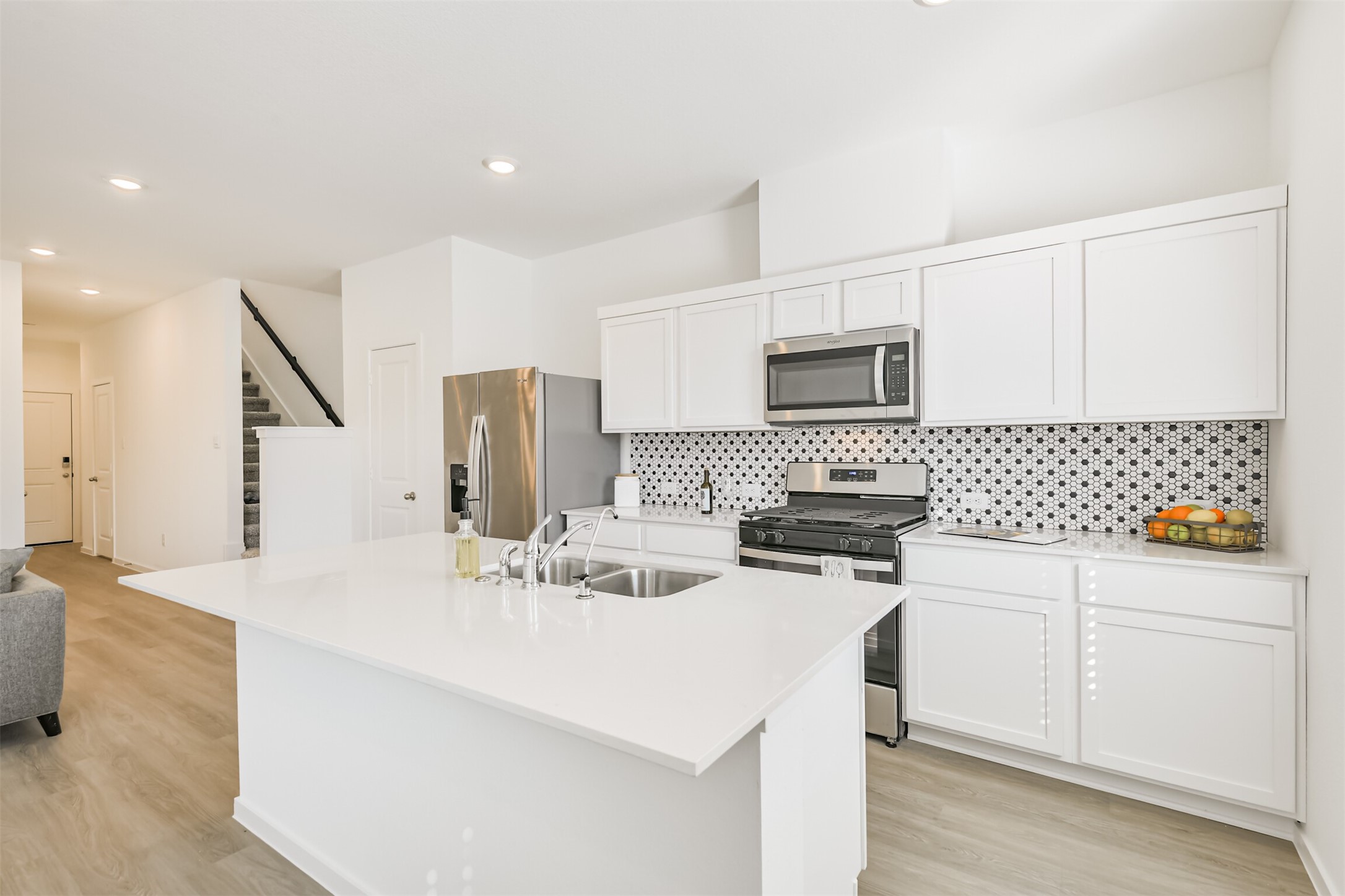 819 Sweet Jubilee Lane Houston, TX 77090 - Photo 6 of 25 a kitchen with stainless steel appliances a stove a sink a refrigerator a microwave a refrigerator and cabinets