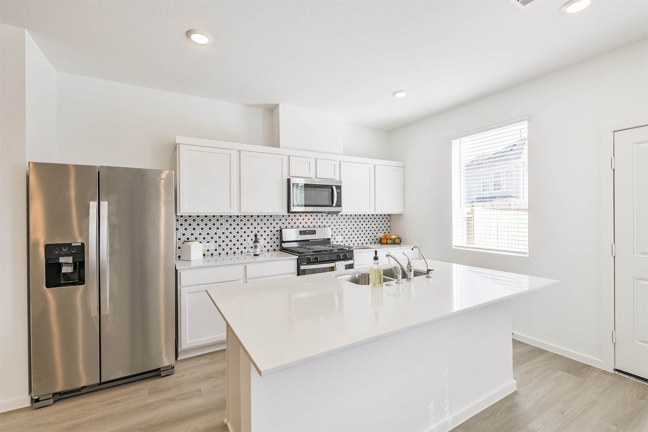 819 Sweet Jubilee Lane Houston, TX 77090 - Photo 7 of 25 a kitchen with stainless steel appliances a sink stove and refrigerator