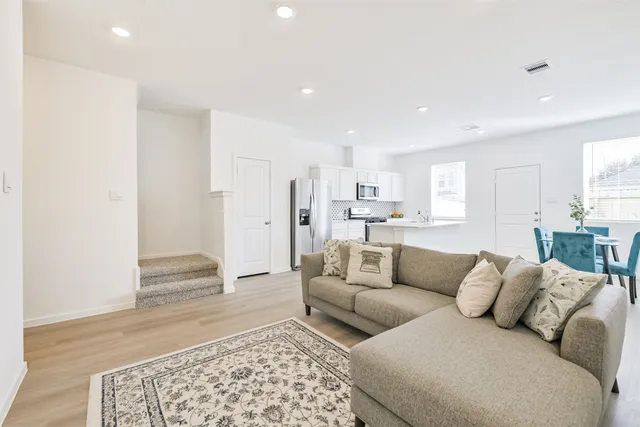 a living room with furniture and a rug