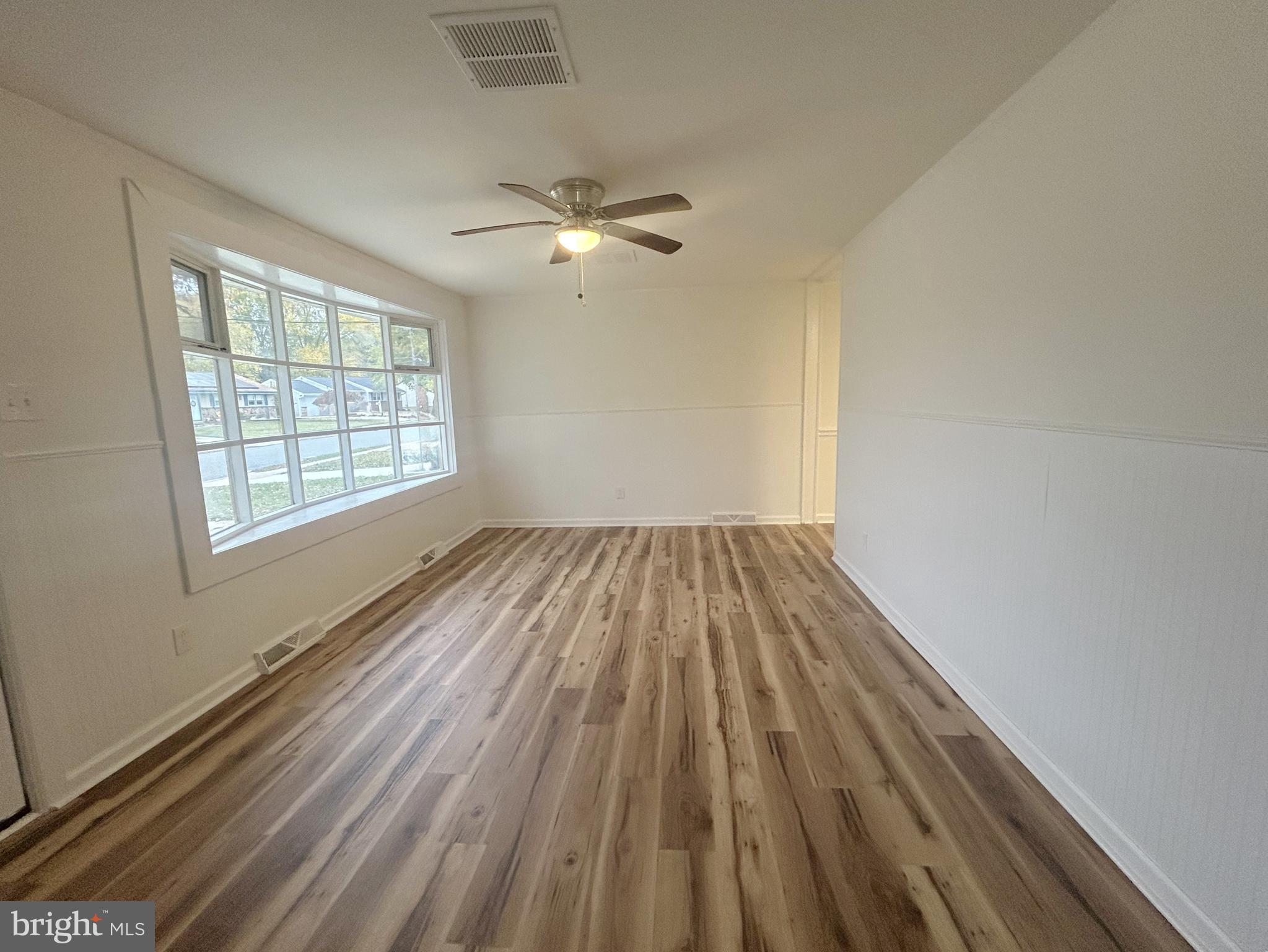 15 Livingstone Road Sewell, NJ 08080 - Photo 3 of 16 a view of empty room with wooden floor and fan