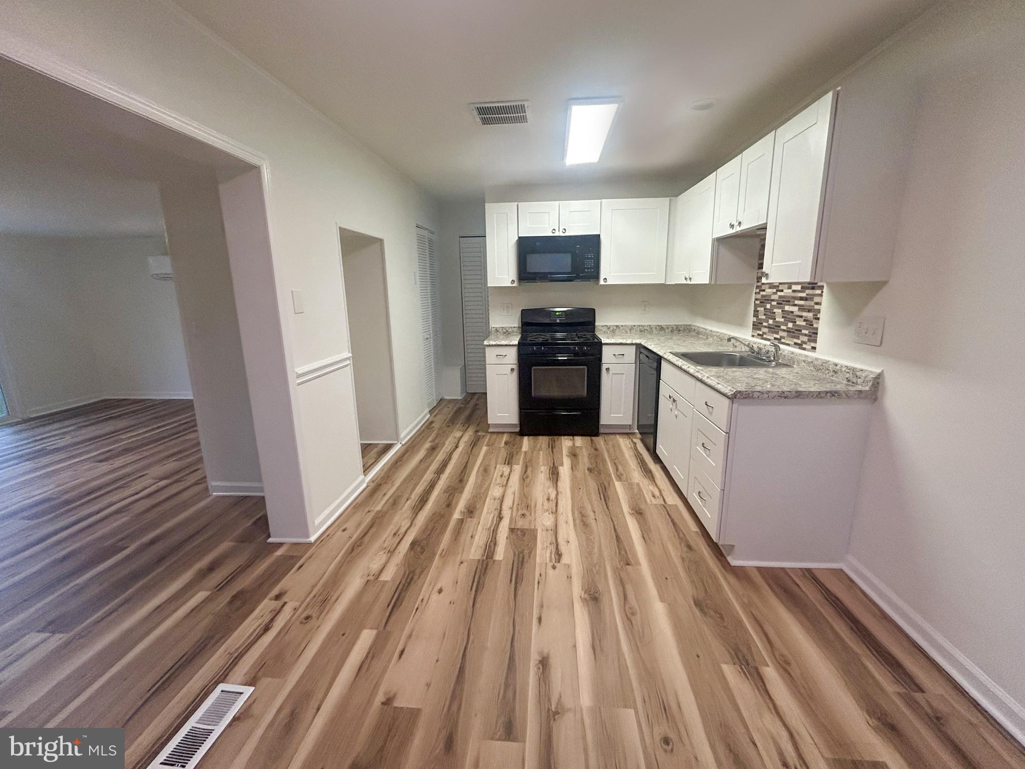 15 Livingstone Road Sewell, NJ 08080 - Photo 5 of 16 a kitchen with stainless steel appliances granite countertop a sink stove and cabinets
