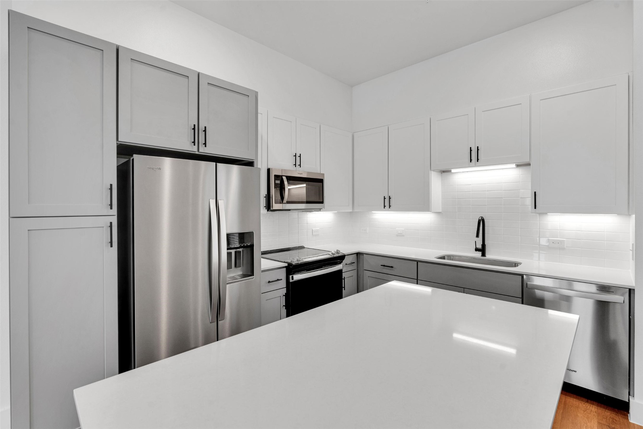 1521-222 Bernard Street Rowlett, TX 75089 - Photo 4 of 38 a kitchen with stainless steel appliances a refrigerator sink and white cabinets