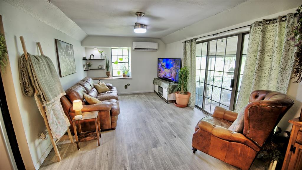 140 Elm Road Nocona, TX 76255 - Photo 8 of 26 a living room with furniture a flat screen tv and a window