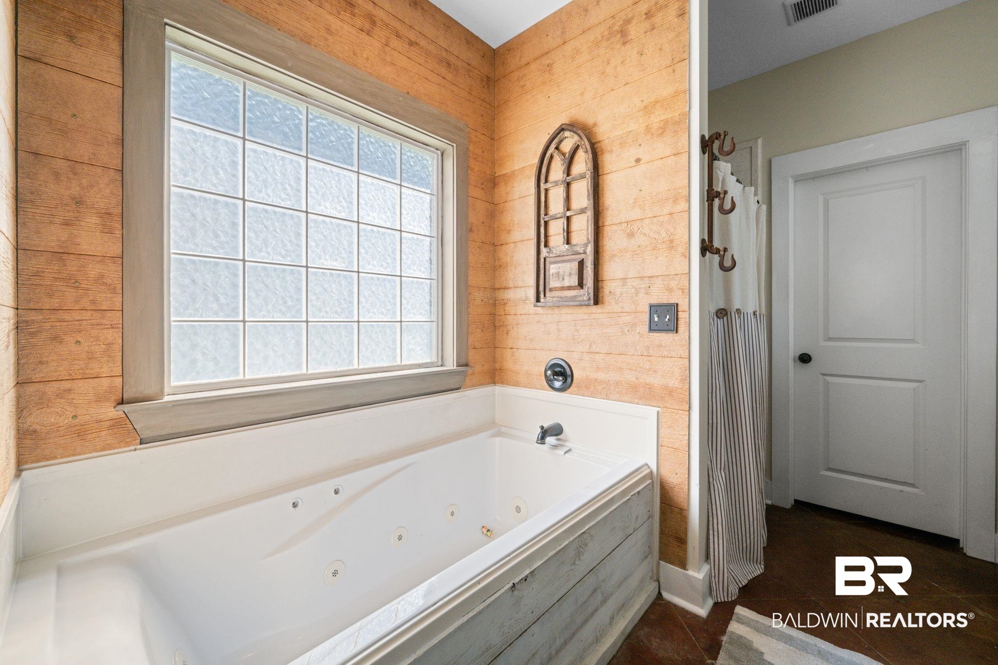 15635 North A N Brady Road Bay Minette, AL 36507 - Photo 23 of 51 Bathroom featuring shower with separate bathtub, wood walls, and tile patterned floors