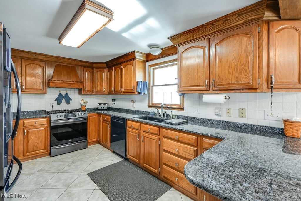 4220 Lake Heights Road Northwest Canton, OH 44708 - Photo 2 of 48 Kitchen featuring all new appliances '23, custom exhaust hood, 5 burner range, ss refrigerator and dw, oak cabinets, granite countertops