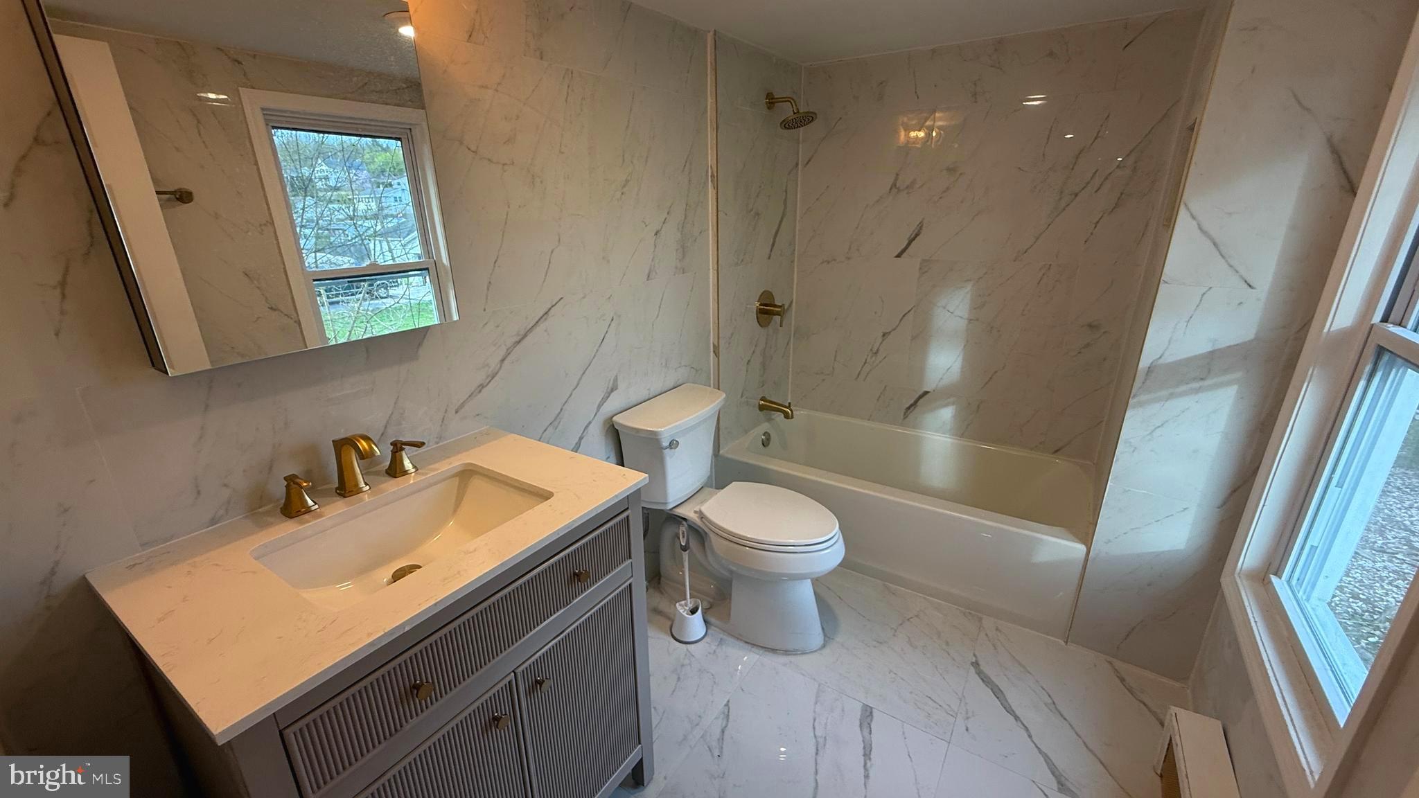 210 Cherry Street Duryea, PA 18642 - Photo 17 of 26 a bathroom with a sink a toilet and shower
